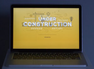 Yellow under construction image on a laptop.